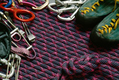 Das Bild zeigt Kletterausr�stung: Seil, Karabiner, Achter, Kletterschuhe