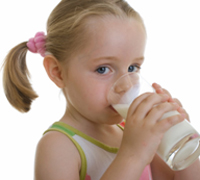 Ein blondes M�dchen trinkt ein Glas Milch