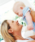 Eine Mutter h�lt lachend ihr Kind hoch