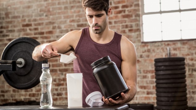 Ein Mann mixt sich ein Proteinshake.